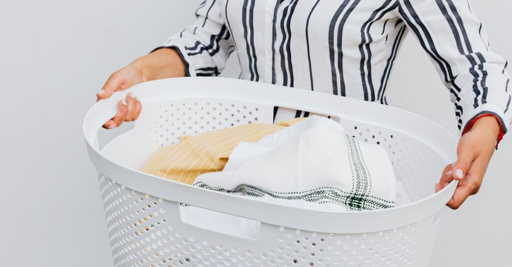 A close-up of a woman holding a white laundry basket filled with fresh, clean clothes.
